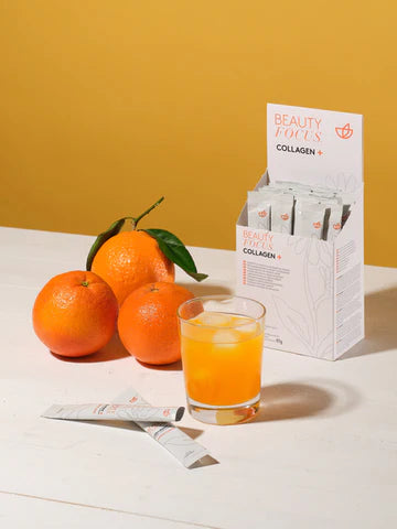 Packung Collagen plus von Nu Skin, 3 Orangen und ein Glas mit Collagendrink
