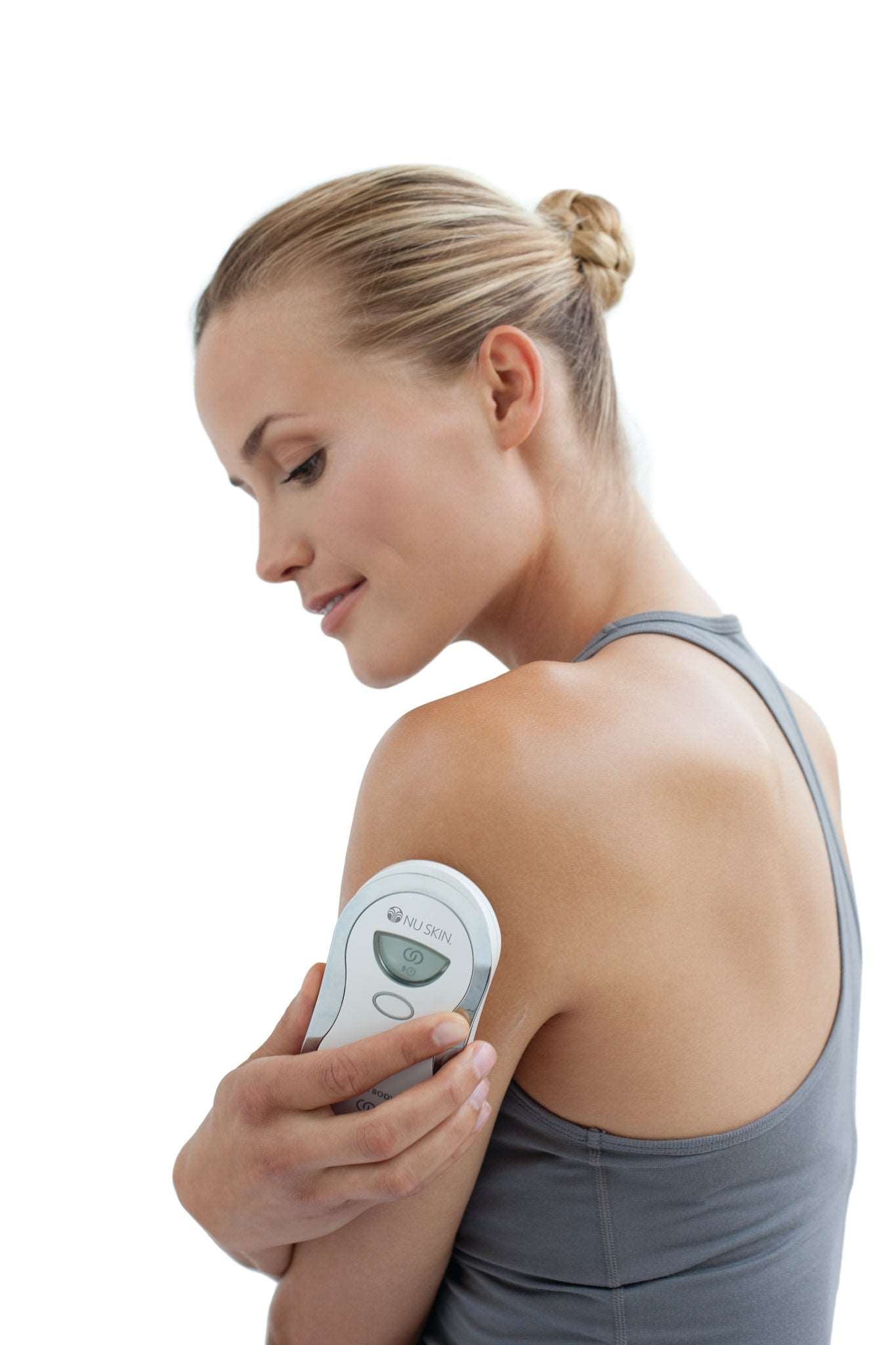 Woman treats arm with body Galvanic Spa from Nu Skin against winky arms