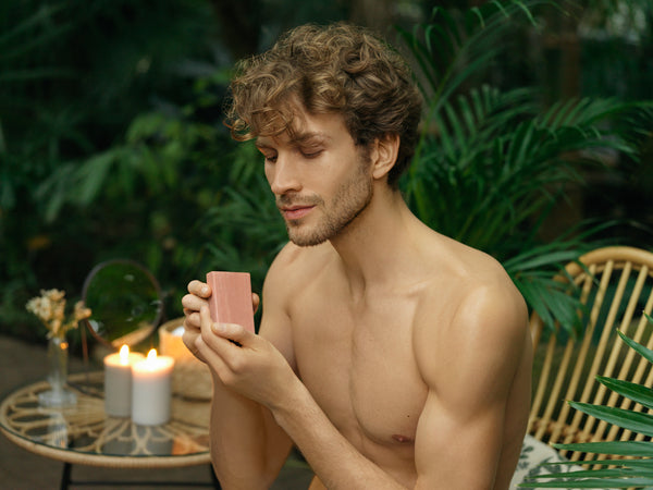 Man with naked upper body holding a Epoch Polishing Bar 